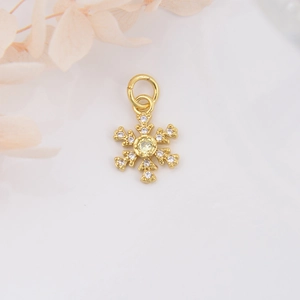 Detail of 18k gold plated snowflake pendant with sparkling yellow zircon stones