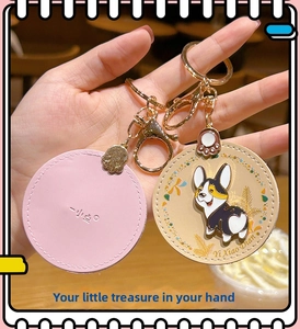 Close-up of leather Corgi keychains with stitching and gold alloy claw pendants