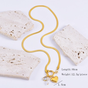 Detail of gold snake chain with heart, teardrop gem, and pearl pendant specifications