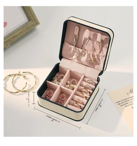 Macro view showing internal sections of portable jewelry box with hooks and ring slots
