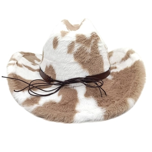 Detail of faux fur cowboy hat featuring brown cow print texture and leather decorative band