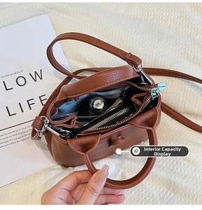 Internal capacity display of caramel leather bucket bag showing everyday essentials