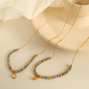 French style gold plated snake chain necklace with grey faceted beads and zircon charm