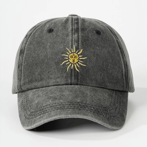 Close-up of vintage washed cotton baseball cap featuring detailed sun face embroidery