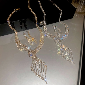 Detail of luxury gold and silver leaf necklaces with sparkling rhinestones in V-shape