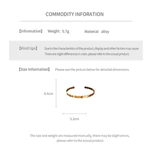 Size chart for golden twisted geometric open bangle showing dimensions 6.4cm and 5.2cm