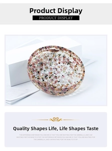 Macro view of round resin jewelry tray with colorful crushed crystals and gold foil