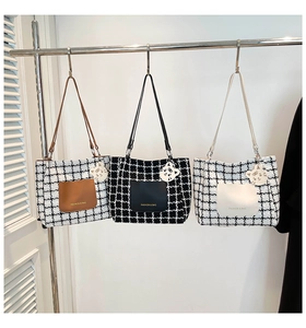 Detailed view of tweed tote bags in various plaid patterns with fashion leather pockets