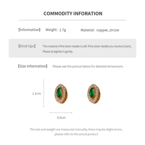 Detail showing vintage oval emerald zircon earrings with measurements 1.1cm by 0.6cm