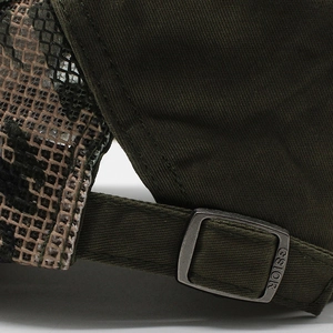 Detail of adjustable metal buckle and camouflage mesh on green summer sun cap