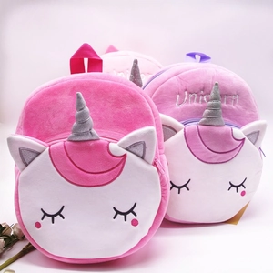 Close-up of soft plush unicorn backpack with colorful fabric and 3D silver horn detail