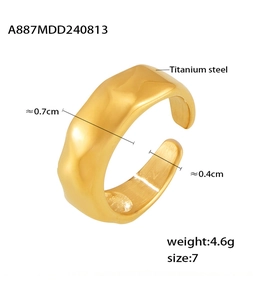 Macro shot of gold-plated titanium steel ring with irregular lava texture and dimensions