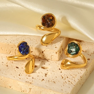 French vintage stainless steel gold-plated rings with natural stones on cream silk