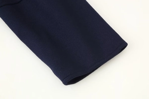 Close-up of deep blue wool jacket sleeve showing high-quality stitching and fabric texture