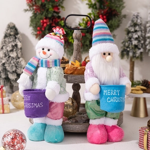 Detail of plush Snowman and Santa Claus figurines holding colorful Christmas storage buckets