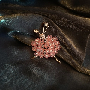 Macro detail of ballerina brooch featuring rose gold plating and pink floral crystals