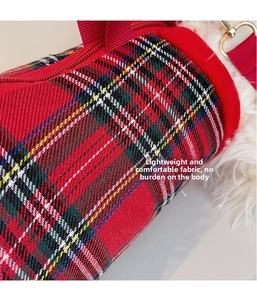 Detail of red and green plaid fabric bag with golden metal hook and soft plush lining