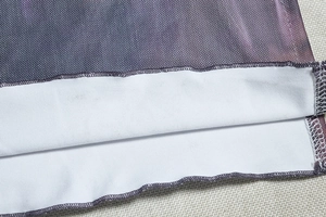 Detailed close-up of double-layer mesh fabric texture and purple printed hem stitching