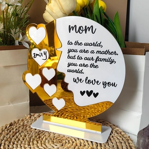 Detail of acrylic Mother's Day plaque with gold mirror silhouette and photo heart cutouts