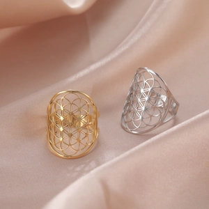 Detailed close-up of hollow flower geometric rings on premium beige satin background