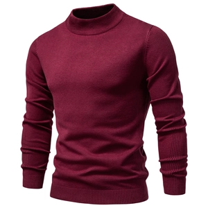 Close-up of wine red turtleneck sweater showing ribbed cuffs and knit texture