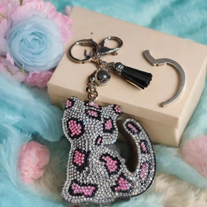 Makroaufnahme vom Kristall Leopard Schlüsselanhänger mit rosa Strass und schwarzer Quaste