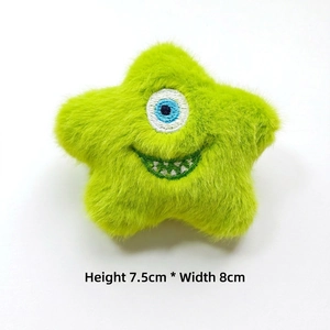 Detail view of a plush green star monster toy, size 7.5cm high and 8cm wide
