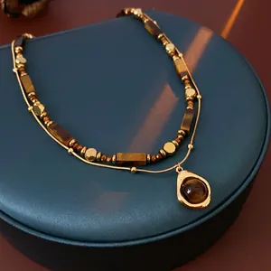 Double-layered tiger eye stone necklace with gold-plated beads and teardrop pendant