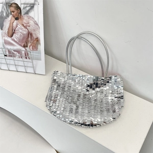 Close-up of sparkling silver sequin fabric on a large capacity tote with metallic finish