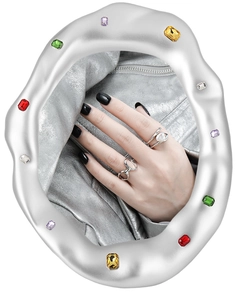 Detail of silver S925 ring featuring large pearl and hollow geometric design on hand