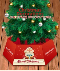 Detail of red hexagonal Christmas tree collar featuring festive Santa Claus graphics