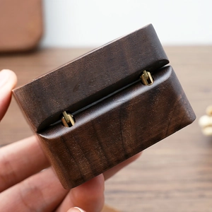 Detail shot of sturdy metal hinge on a premium walnut wood jewelry ring box