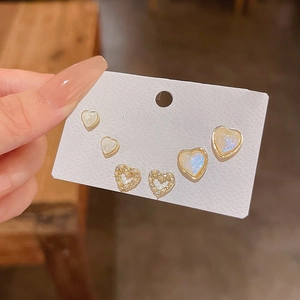 Close-up of S925 silver needle heart stud earring set with cat eye stones and pearls