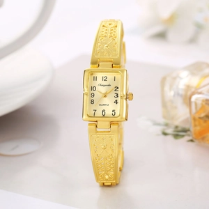 Detailed close-up of a gold square quartz watch with hollow-out floral pattern bracelet