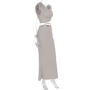 Detailed side view of beige two-piece set featuring a cropped vest and maxi skirt