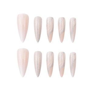 Long stiletto press-on nails with nude base and silver glitter wave patterns