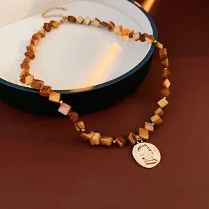 Vintage brown square beaded necklace with a golden coin portrait pendant for women