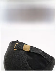 Detail of winter baseball cap with adjustable bronze metal buckle and grey textured fabric