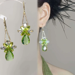 Green crystal drop earrings with pear-shaped stones and floral cluster gold setting