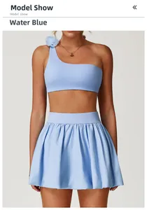 Detail of the light blue tennis skirt and one-shoulder top with floral shoulder accents