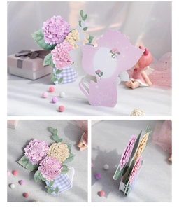 Detail of 3D pop-up hydrangea card with blue floral vase and pink tea cup cutout