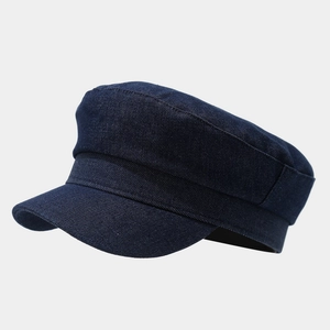 Detail view of the vintage dark blue denim newsboy cap showing twill fabric texture