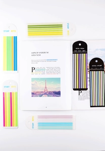 Detailed view of colorful PET sticky notes strips used for marking pages in an open book