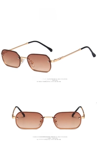 Detail view of vintage rimless square sunglasses with spiral metal temples and brown gradient lenses