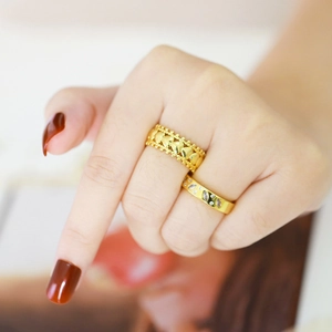 Elegant gold stacked heart ring and leaf-shaped crystal ring on a model's hand