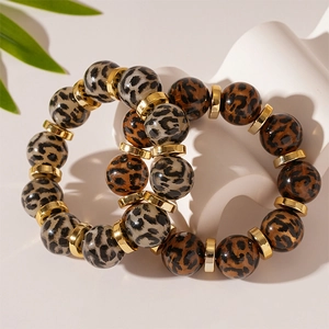 Set of two vintage leopard print acrylic bead bracelets with gold polished metal accents