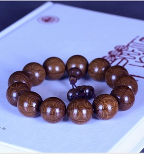 Macro detail of natural Liu Dao Mu wooden prayer beads with rich texture and grain