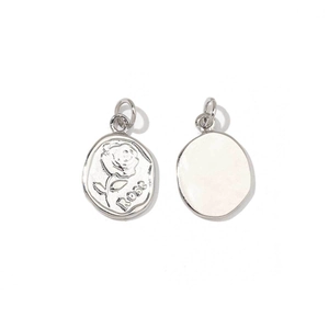 Detailed view of silver rose pendant charms with engraved flower pattern and Rose text