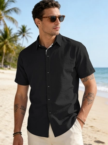 Detailed close-up of men's black textured casual short-sleeved button-up beach shirt