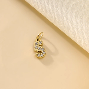 Macro shot of a gold-plated number 5 pendant with zircon micro-pave crystals